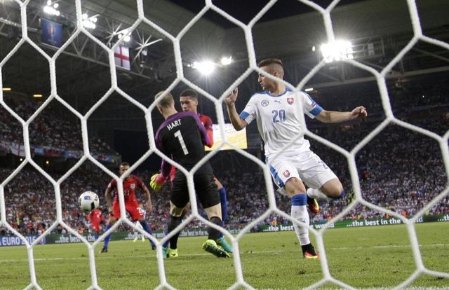 Slovakia's Robert Mak (right) watches as England goalkeeper Joe Hart (left) collides with England's Chris Smalling during the Euro 2016 Group B football match between Slovakia and England at the Geoffroy Guichard stadium in Saint-Etienne, France. (AP Photo) Slovakia's Robert Mak (right) watches as England goalkeeper Joe Hart (left) collides with England's Chris Smalling during the Euro 2016 Group B football match between Slovakia and England at the Geoffroy Guichard stadium in Saint-Etienne, France. (AP Photo)