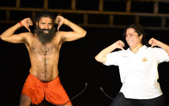 Ramdev and BJP leader Meenakshi Lekhi perform yoga during the rehearsals for the upcoming International Yoga Day at Rajpath in New Delhi. (Virendra Singh Gosain/HT Photo)