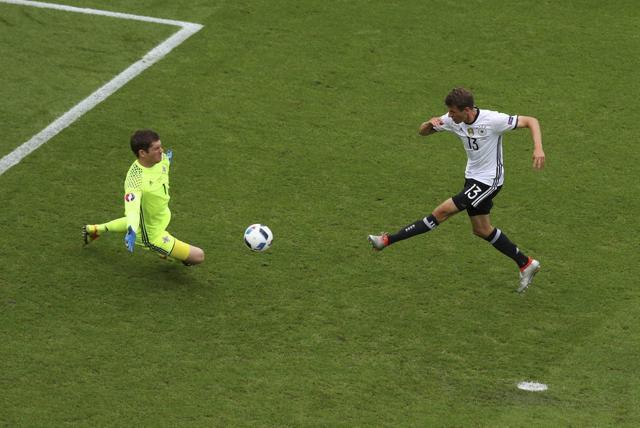 Northern Ireland goalkeeper Michael McGovern, left, blocks a shot by Germany's Thomas Mueller. (AP)
