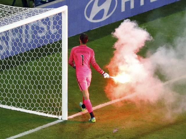 Turkey goalkeeper Volkan Babacan carries away a burning flare during the Euro 2016 Group D match between the Czech Republic and Turkey at the Bollaert stadium in Lens, France. (AP Photo) Turkey goalkeeper Volkan Babacan carries away a burning flare during the Euro 2016 Group D match between the Czech Republic and Turkey at the Bollaert stadium in Lens, France. (AP Photo)