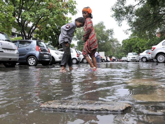 Kids play in the rainwater at Sector 17, Chandigarh, on Wednesday. (Keshav Singh/HT)
