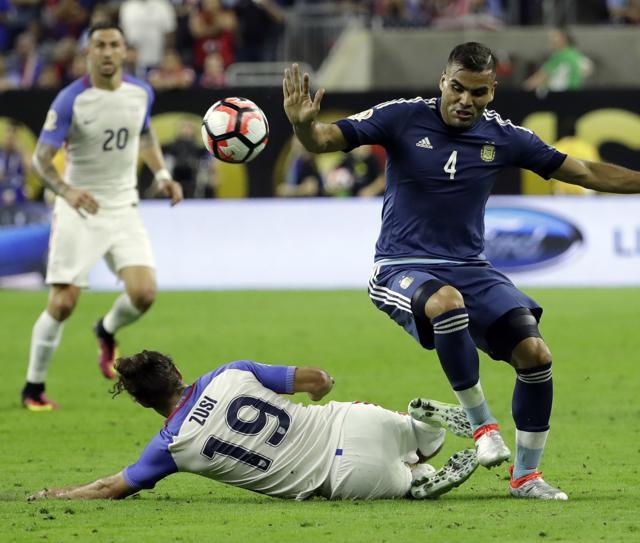 Argentina defender Gabriel Mercado (4) gets around a tackle by United States midfielder Graham Zusi (19) during a Copa America Centenario semifinal, in Houston. (AP Photo) Argentina defender Gabriel Mercado (4) gets around a tackle by United States midfielder Graham Zusi (19) during a Copa America Centenario semifinal, in Houston. (AP Photo)