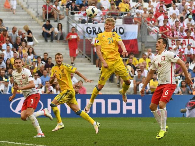 Ukraine's midfielder Olexandr Zinchenko (C) jumps for a header. (AFP)