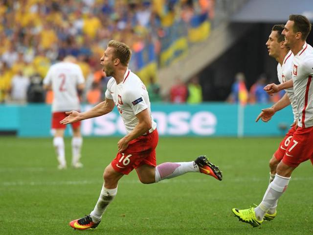 Jakub Blaszczykowski (L) is joined by teammates in celebration of his goal. (AFP)