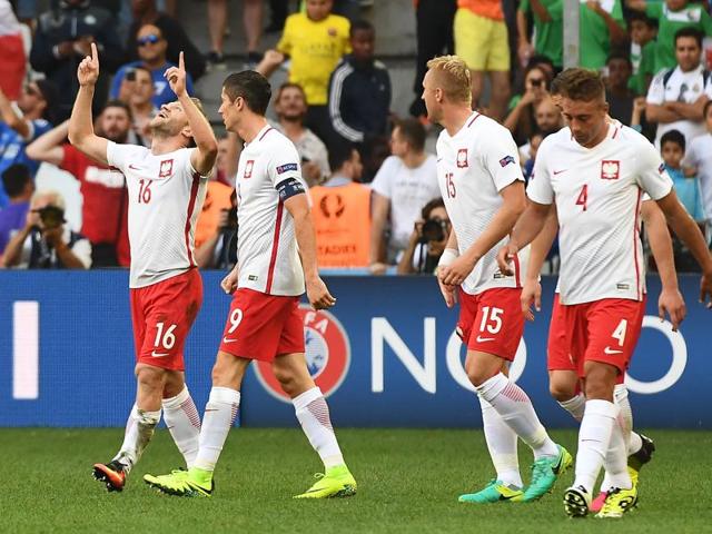 Jakub Blaszczykowski (L) looks skyward in celebration after scoring. (AFP)