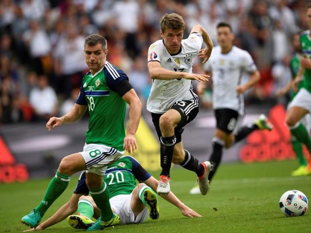Thomas Mueller (R) and Northern Ireland's Craig Cathcart and Aaron Hughes vie for possession. (AFP)