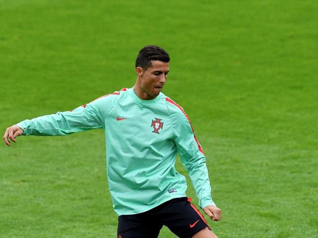 Portugal's forward Cristiano Ronaldo plays with the ball during a training session at the team's base camp in Marcoussis, south of Paris.(AFP Photo)