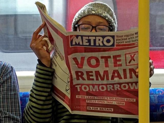 There is only one question on Britain’s mind today: will the country vote to leave the European Union or remain? On the London underground, a woman reads a newspaper with a 'vote remain' advertisement on the front page.   (REUTERS/Russell Boyce) 