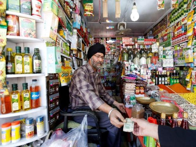 Afghan Sikh Jagtar Singh Laghmani, 50, accepts money from a customer at his traditional herb shop in Kabul, Afghanistan . (Reuters) Afghan Sikh Jagtar Singh Laghmani, 50, accepts money from a customer at his traditional herb shop in Kabul, Afghanistan . (Reuters)