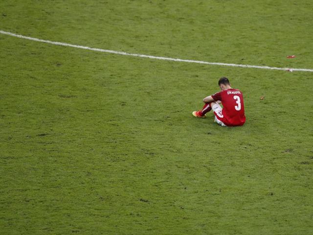 Austria's Aleksander Dragovic sits dejected after Austria’s loss eliminated them from the competition. (AP)