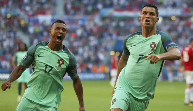 Portugal's Cristiano Ronaldo celebrates with teammate Nani (left) after scoring his side's second goal during the Euro 2016 Group F football match between Hungary and Portugal at the Grand Stade in Decines-Charpieu, near Lyon. (AP Photo) Portugal's Cristiano Ronaldo celebrates with teammate Nani (left) after scoring his side's second goal during the Euro 2016 Group F football match between Hungary and Portugal at the Grand Stade in Decines-Charpieu, near Lyon. (AP Photo)