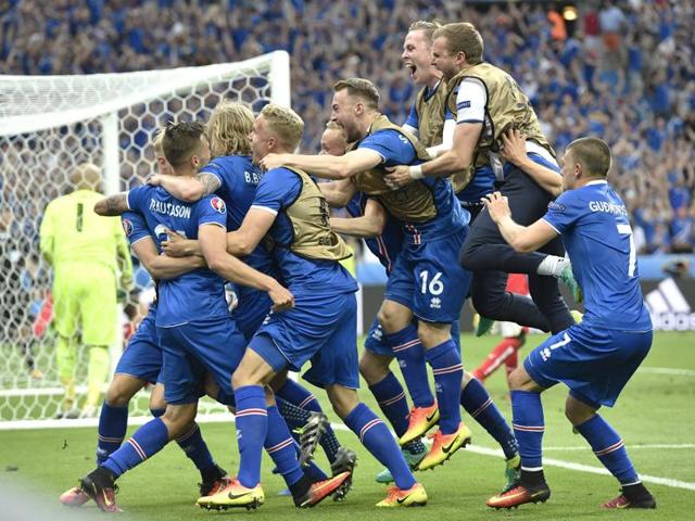 Iceland players celebrate a goal by Iceland's Arnor Ingvi Traustason during the Euro 2016 Group F match against Austria at the Stade de France in Saint-Denis, north of Paris, on June 22, 2016. Iceland won 2-1 to enter the round of 16 in their first appearance in a major international tournament. (AP)