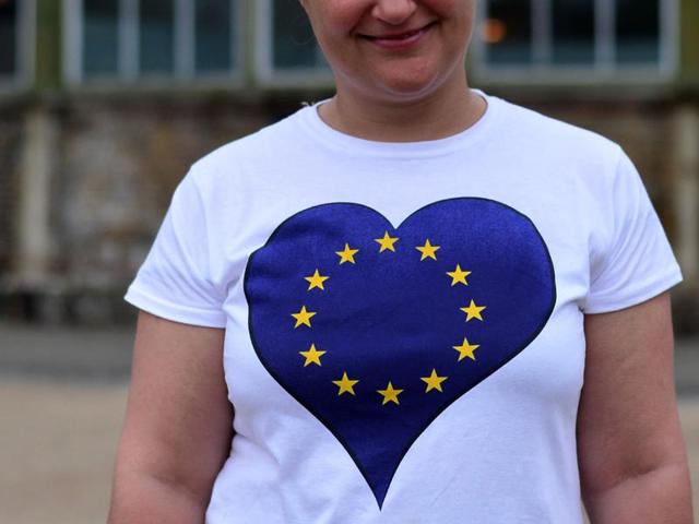 A non-British EU citizen, unable to vote in the EU referendum, poses wearing an EU-flag themed t-shirt outside the polling station at Greenwich Heritage Centre in London. (AFP Photo) 