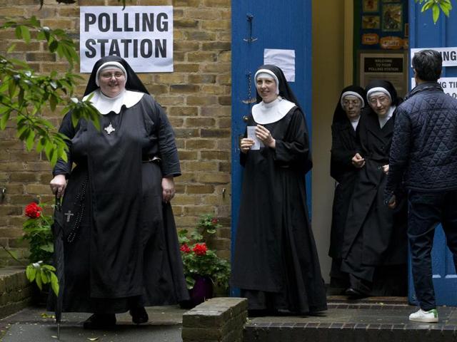 Nuns leave after casting their votes at a polling station in London. (AFP) 