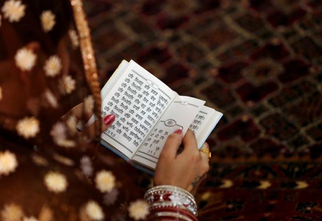 An Afghan Sikh woman prays inside a Gurudwara, or a Sikh temple, during a religious ceremony in Kabul, Afghanistan. (Reuters) An Afghan Sikh woman prays inside a Gurudwara, or a Sikh temple, during a religious ceremony in Kabul, Afghanistan. (Reuters)