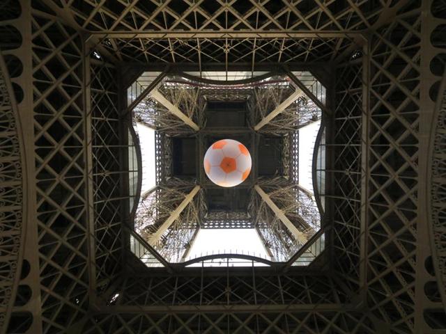 A giant football is suspended under the Eiffel Tower near the fan zone at the Champs de Mars.  (Reuters Photo) 