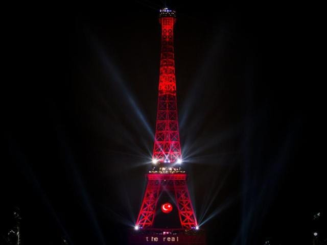 The Eiffel Tower lit in Turkey's colours, as seen from the fan zone, following the screening of the Euro 2016 football match between Germany and Ukraine.  (AFP Photo) 