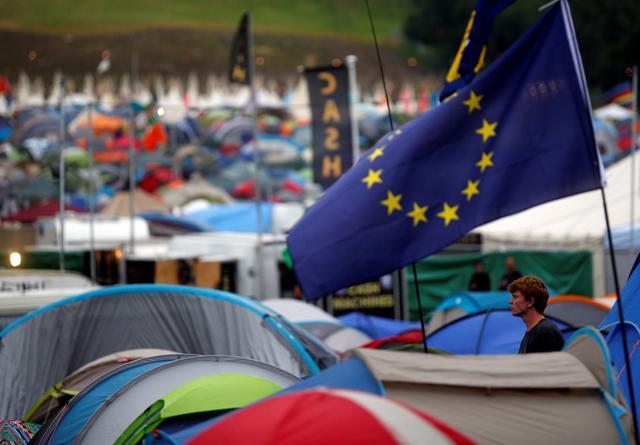 A reveller stands in front of a tent with the European Union flag at Worthy Farm in Somerset during the Glastonbury Festival in Britain on June 23, 2016. (REUTERS) A reveller stands in front of a tent with the European Union flag at Worthy Farm in Somerset during the Glastonbury Festival in Britain on June 23, 2016. (REUTERS)