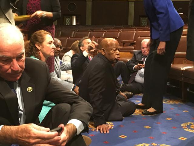 This photo provided by Rep. John Yarmuth, D-Ky., shows Democrat members of Congress, including Rep. John Lewis, D-Ga., center, and Rep. Joe Courtney, D-Conn., left, participate in sit-down protest seeking a a vote on gun control measures, Wednesday, June 22, 2016, on the floor of the House on Capitol Hill in Washington. (AP Photo) This photo provided by Rep. John Yarmuth, D-Ky., shows Democrat members of Congress, including Rep. John Lewis, D-Ga., center, and Rep. Joe Courtney, D-Conn., left, participate in sit-down protest seeking a a vote on gun control measures, Wednesday, June 22, 2016, on the floor of the House on Capitol Hill in Washington. (AP Photo)