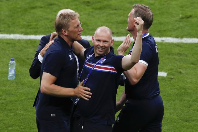 Iceland coach Heimir Hallgrimsson, left, celebrates with team staff at the end of the Euro 2016 Group F match between Iceland and Austria. (AP)
