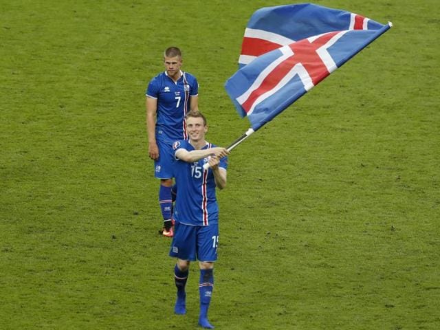 Iceland's Jon Dadi Bodvarsson waves his national flag at the end of the game. (AP)