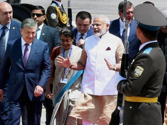 Prime Minister Narendra Modi walks with his Uzbek counterpart Shavkat Miromonovich Mirziyoev upon his arrival in Tashkent on Thursday. (PTI Photo) Prime Minister Narendra Modi walks with his Uzbek counterpart Shavkat Miromonovich Mirziyoev upon his arrival in Tashkent on Thursday. (PTI Photo)