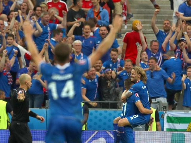 Iceland's Arnor Ingvi Traustason, celebrates his winning goal while carrying his teammate Birkir Bjarnason, right. (AP)