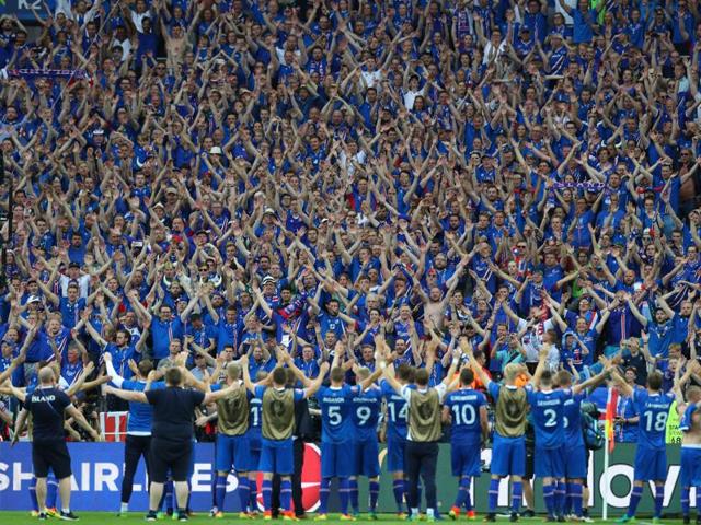 Iceland's players celebrate their victory with their supporters at the end of the match. (AP)