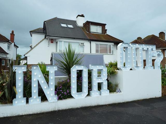 An illuminated ‘In or Out’ sign is pictured outside a house in Hangleton near Brighton in southern England as Britain holds a referendum on wether to stay or leave the European Union (EU). (AFP Photo) An illuminated ‘In or Out’ sign is pictured outside a house in Hangleton near Brighton in southern England as Britain holds a referendum on wether to stay or leave the European Union (EU). (AFP Photo)