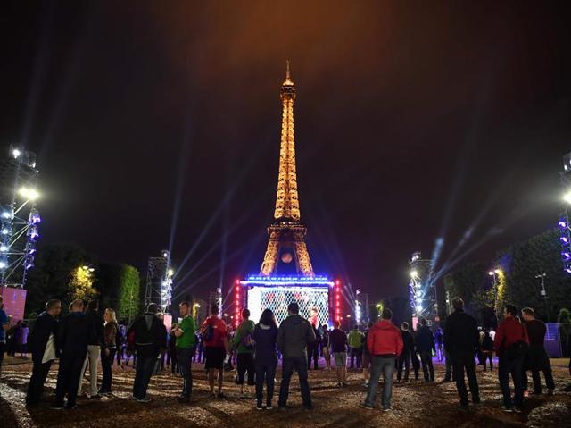 Football supporters watch the Euro 2016 group B football match between Slovakia and England at Paris' fan zone near the Eiffel tower on the Champs de Mars in Paris. (AFP Photo) 