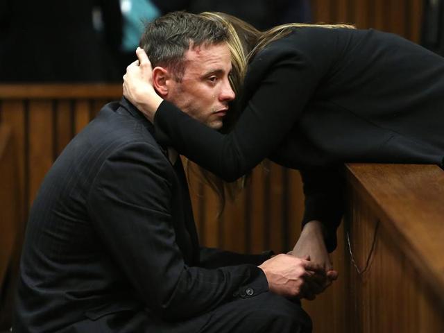 South African Paralympian Oscar Pistorius reacts as his sister holds him during the third day of his resentencing hearing for the 2013 murder of his girlfriend Reeva Steenkamp at the Pretoria high court.(AFP Photo)
