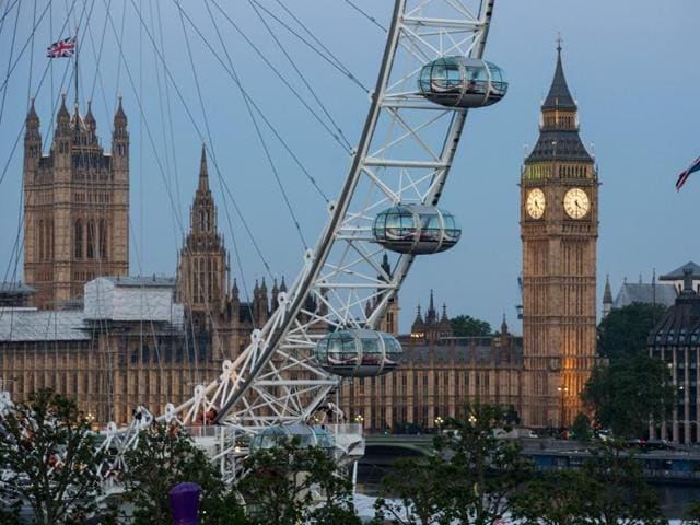 A Union flag flies beside the London Eye in front of the Queen Elizabeth Tower (Big Ben) and The Houses of Parliament in London on June 24, 2016. Britain's economy was plunged into a dizzying unknown on Friday as the country chose to exit the EU. (AFP)