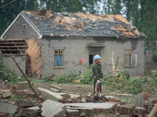 A worker stands among the rubble of destroyed houses after a tornado in Funing, in Yancheng, in China's Jiangsu province. (AFP) A worker stands among the rubble of destroyed houses after a tornado in Funing, in Yancheng, in China's Jiangsu province. (AFP)