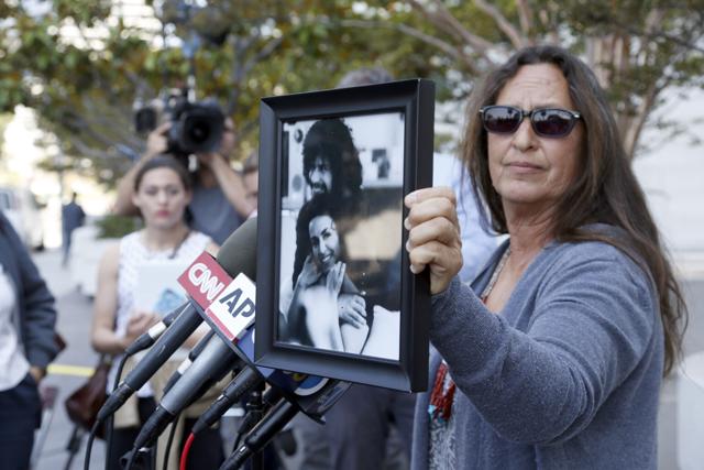 Janet Wolfe holds a photo of her brother Randy Wolfe, better known as Randy California, a member of the band Sprit outside federal court, Thursday, June 23, 2016 in Los Angeles. (AP) Janet Wolfe holds a photo of her brother Randy Wolfe, better known as Randy California, a member of the band Sprit outside federal court, Thursday, June 23, 2016 in Los Angeles. (AP)