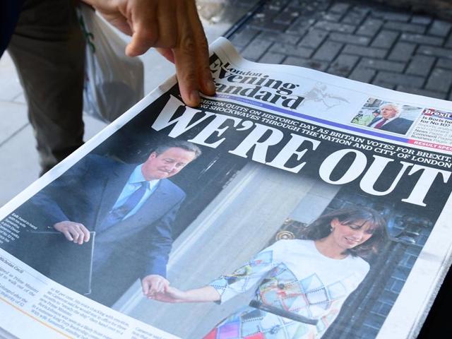 A man takes a copy of the London Evening Standard on Friday with the front page reporting the resignation of British Prime Minister David Cameron and the vote to leave the EU in a referendum.(AFP)