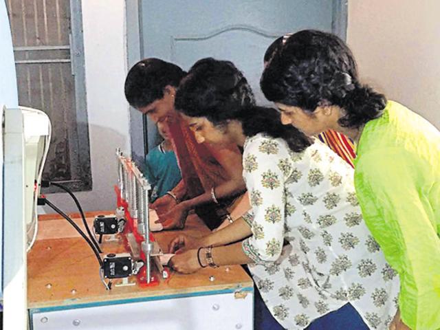 Devika Chhipa Kumar with her sister Salon (right) learns to make sanitary pads along with a rural woman at Dityakheri village in Jhalawar.(AH Zaidi/ HT Photo)