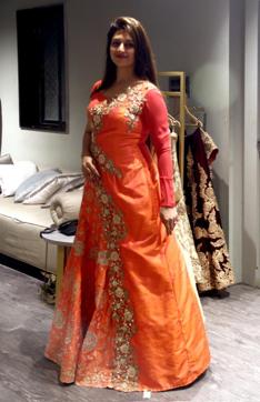 Divyanka tries on an orange lehenga at the store. Divyanka tries on an orange lehenga at the store.