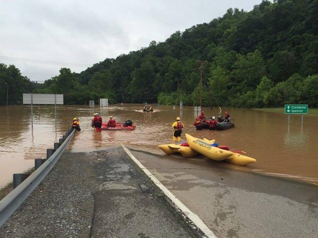 Emergency crews take out boats on a flooded I-79 at the Clendenin Exit, after the state was pummeled by up to 10 inches of rain on Thursday, causing rivers and streams to overflow into neighboring communities, in Kanawha County, West Virginia.  (REUTERS)