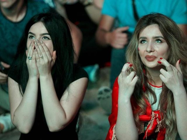 Albania fans react as they sit in the fan zone of Tirana during the Euro 2016 match between Albania and Romania on July 19 2016. (AFP PHOTO) Albania fans react as they sit in the fan zone of Tirana during the Euro 2016 match between Albania and Romania on July 19 2016. (AFP PHOTO)