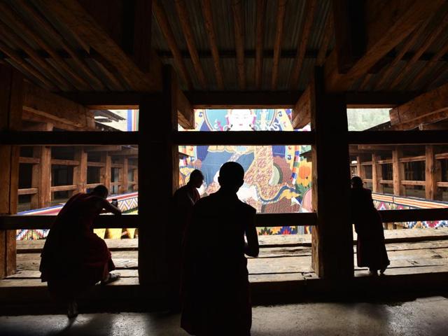 Young monks look on at a thangka depicting Guru Padmasambhava during celebrations on his birth anniversary at the Paro Rinpung Dzong in Paro, Bhutan. (Gurinder Osan/HT PHOTO)
