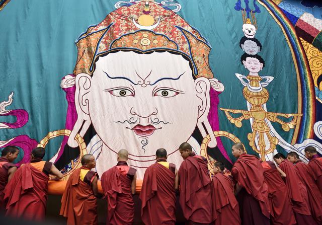 Monks assist in unfurling a thangka depicting Guru Padmasambhava at the birth anniversary celebrations. (Gurinder Osan/HT PHOTO) Monks assist in unfurling a thangka depicting Guru Padmasambhava at the birth anniversary celebrations. (Gurinder Osan/HT PHOTO)