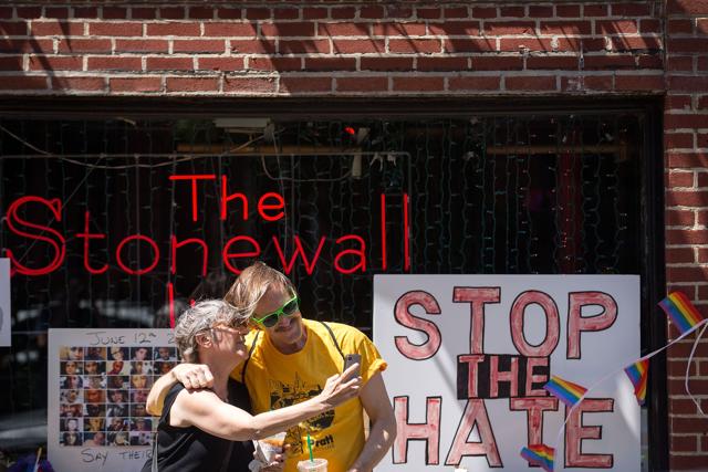 People take ‘selfies' in front of the Stonewall Inn. President Barack Obama designated the inn and approximately 7.7 acres surrounding it as the first national monument dedicated "to tell the story of the struggle for LGBT rights."(AFP)