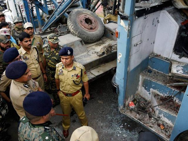 Security forces inspecting the CRPF bus which was attacked by militants on Srinagar-Jammu National High Way at Pampore on the out skirts of Sringar on Saturday.(PTI)