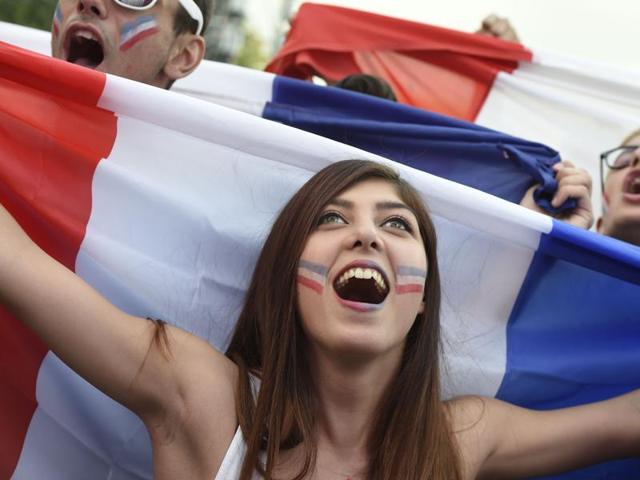 A France's supporter holds a French flag at the fan zone on the Champs de Mars near the Eiffel tower. (AFP Photo) A France's supporter holds a French flag at the fan zone on the Champs de Mars near the Eiffel tower. (AFP Photo)