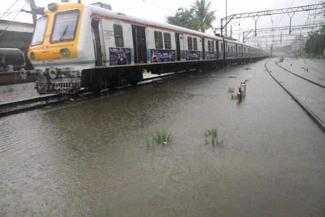 Local train on water logged railway track in Thane on Saturday. (PTI) Local train on water logged railway track in Thane on Saturday. (PTI)