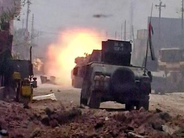 This image made from Associated Press video shows Iraqi troops carry an Iraqi flag on their tanks after a senior Iraqi commander declared that the city of Fallujah was "fully liberated" from Islamic State. (AP) This image made from Associated Press video shows Iraqi troops carry an Iraqi flag on their tanks after a senior Iraqi commander declared that the city of Fallujah was "fully liberated" from Islamic State. (AP)
