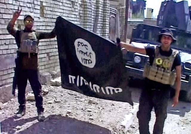 This image made from Associated Press video shows Iraqi troops turn the Islamic State flag upside down in Fallujah. (AP) This image made from Associated Press video shows Iraqi troops turn the Islamic State flag upside down in Fallujah. (AP)
