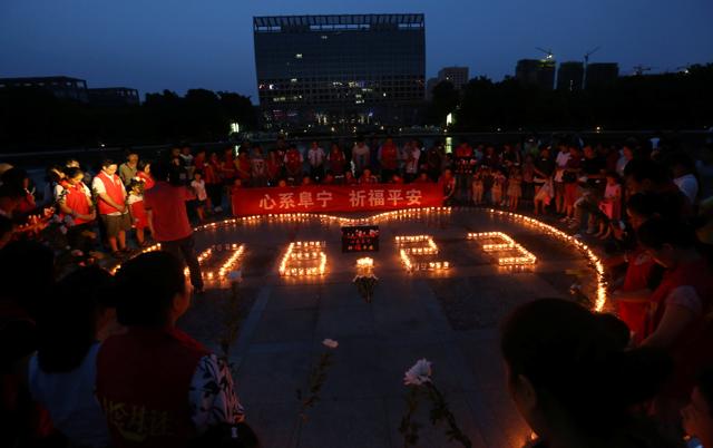 People pray for victims of the tornado which hit Yancheng on Thursday, at a square in Ningbo, Zhejiang province, China on Sunday.(REUTERS) People pray for victims of the tornado which hit Yancheng on Thursday, at a square in Ningbo, Zhejiang province, China on Sunday.(REUTERS)