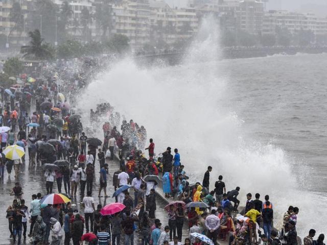 People enjoy the high tide at Marine Drive on Sunday. (Kunal Patil/HT) People enjoy the high tide at Marine Drive on Sunday. (Kunal Patil/HT)