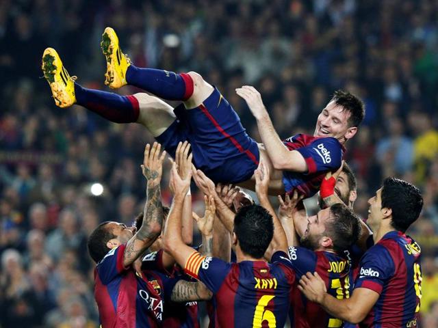 Barcelona's Lionel Messi celebrates his second goal with teammates during their Spanish first division soccer match against Sevilla at Nou Camp stadium in Barcelona November 22, 2014. (REUTERS) Barcelona's Lionel Messi celebrates his second goal with teammates during their Spanish first division soccer match against Sevilla at Nou Camp stadium in Barcelona November 22, 2014. (REUTERS)